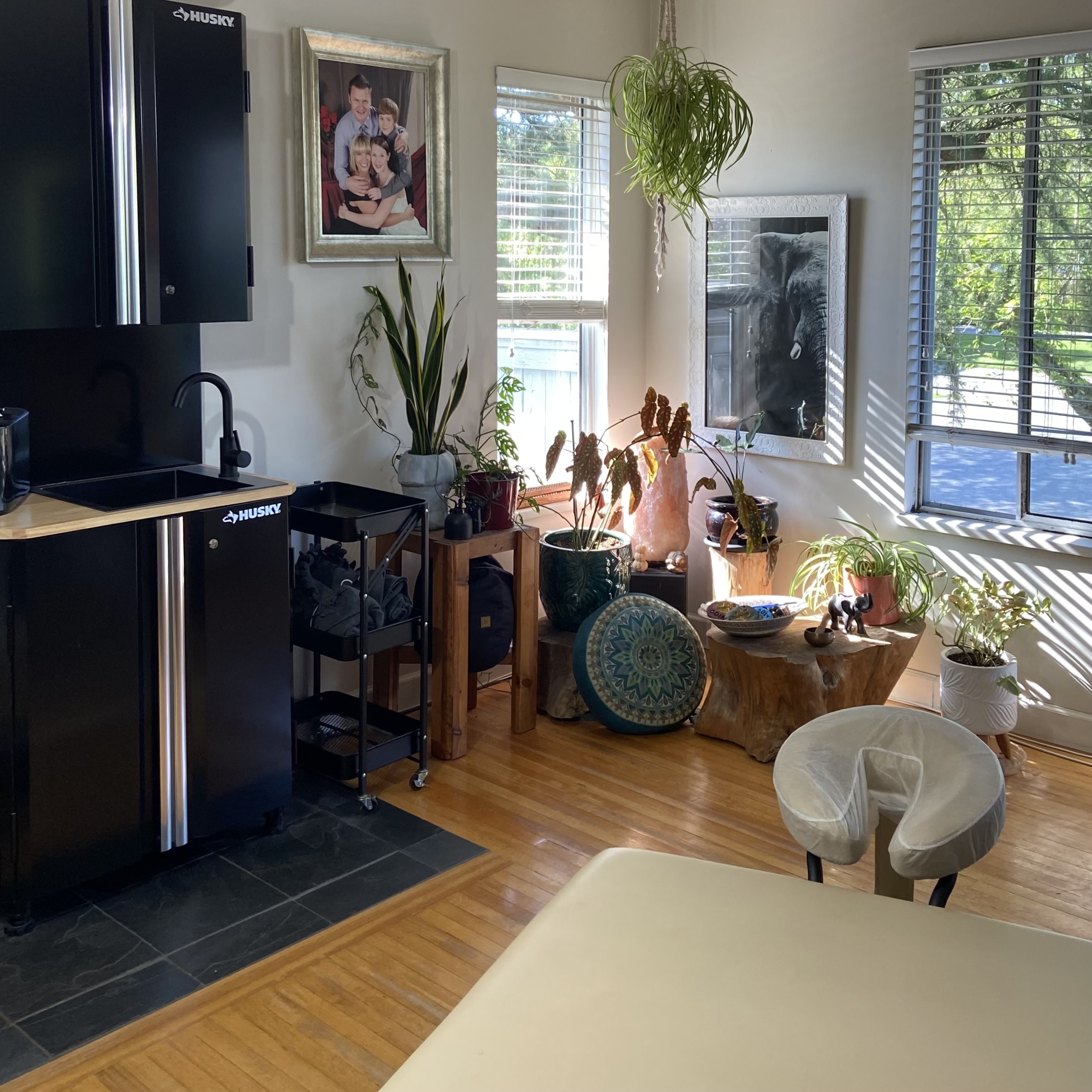 Interior of the Embodiment of Ink private studio with artwork and natural light.